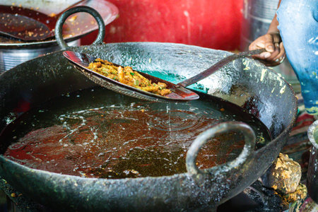 deep frying of big chili at mustered oil at street shop or Mirchi badda local dishes of india at...