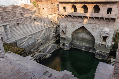 ancient red stone unique stepwell architecture at day from different angle image is taken at Toorji ka Jhalra or stepwell jodhpur rajasthan india.の写真素材
