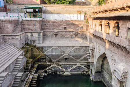 ancient red stone unique stepwell architecture at day from different angle image is taken at Toorji ka Jhalra or stepwell jodhpur rajasthan india.の写真素材