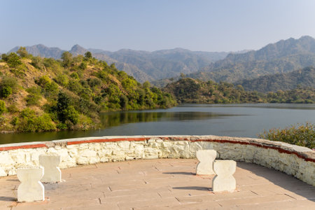 misty mountain landscape with pristine lake at day from flat angleの写真素材