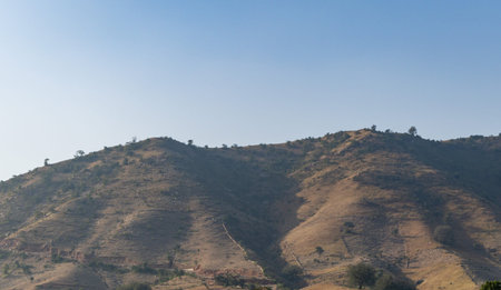 isolated mountain with bright blue sky at morning from flat angleの写真素材