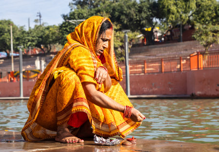 devotee praying for holy god after bathing in holy river water at morning from flat angle