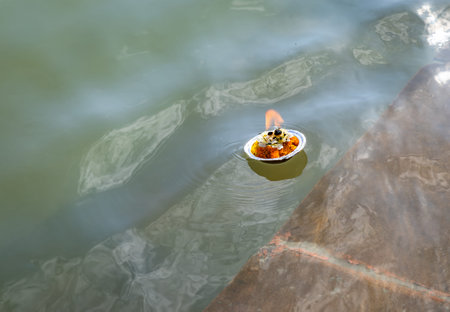 holy offerings oil lamp at river shore on religious occasion at morning from different angleの写真素材