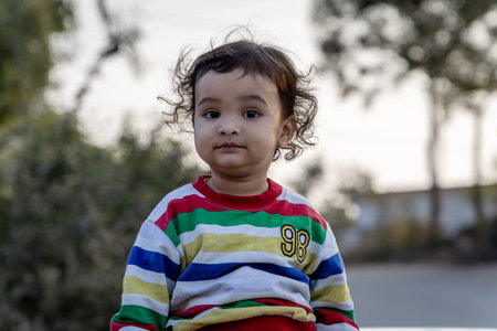 isolated child cute facial expression at morning with blurred backgroundの写真素材