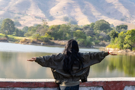 isolated young girl enjoying nature at morning with blurred backgroundの写真素材