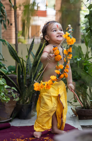 Portrait of cute Indian boy dresses as lord rama with bow at outdoor with blurred background at dayの写真素材