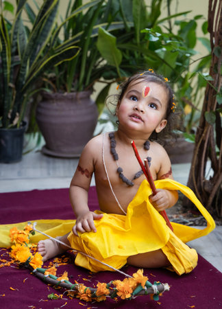 Portrait of cute Indian boy dresses as lord rama with bow at outdoor with blurred background at dayの写真素材