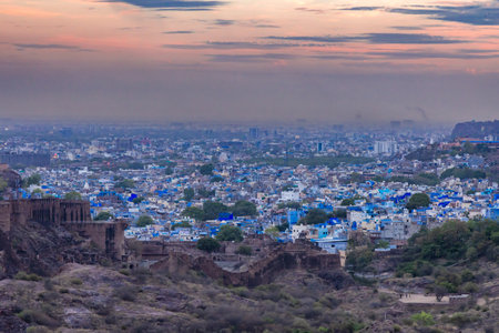 blue city view with dramatic sunset sky at evening from flat angle image is taken at mehrangarh fort jodhpur rajasthan india.の写真素材