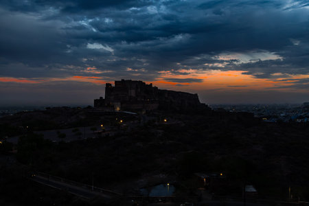 backlit shot of ancient historical fort with dramatic sunset sky at dusk from flat angle image is taken at mehrangarh fort jodhpur rajasthan india.の写真素材