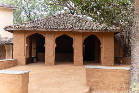 rural tribe traditional home made of bricks and wood in unique design at village at dayの写真素材