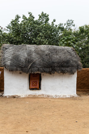 rural tribe traditional home made of twigs and mud at village at dayの写真素材