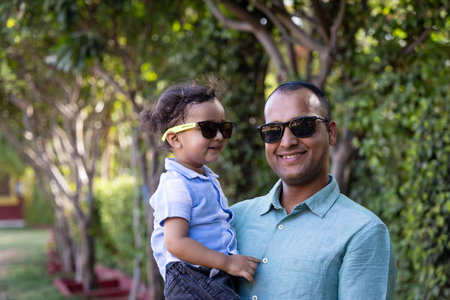 indian father and toddler son cozy moments and facial expression at outdoor park at eveningの写真素材