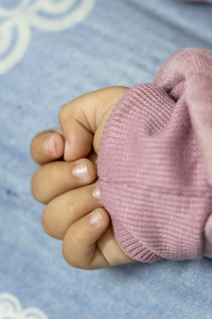 cute toddler fingers at indoor from flat angle