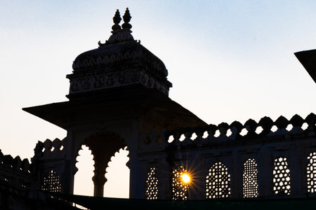 backlit shot of palace exterior with bright blue sky at morningの写真素材