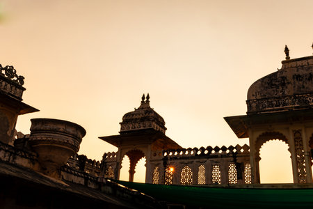 palace exterior with sun star burst and bright orange sky at morningの写真素材