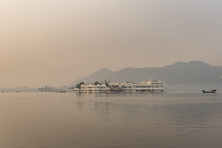 artistic palace architecture at pristine lake and misty mountain backgrounds at morning image is taken at Udaipur rajasthan india.の写真素材