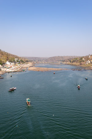 pristine river with tourist ferry boats at morning aerial view image is taken at omkareshwar khandwa madhya pradesh india.の写真素材