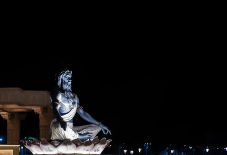 idols of hindu holy sage sitting in mediation at outdoor at nightの写真素材