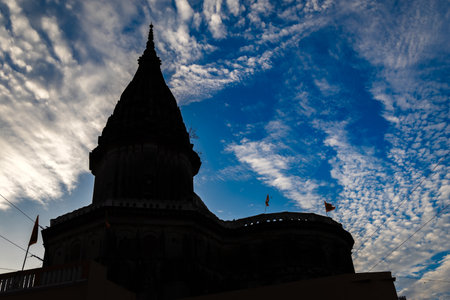 backlit of Sacred Hindu temple with its vibrant architecture and dramatic sky at eveningの写真素材