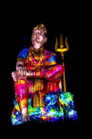 Statue of Hindu God Lord Shiva Ardhnarishwar in Meditation Posture with dramatic laser light effectの写真素材