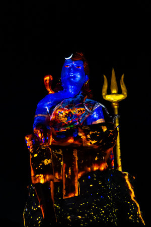 isolated Statue of Hindu God Lord Shiva in Meditation Posture with dramatic laser light effectの写真素材