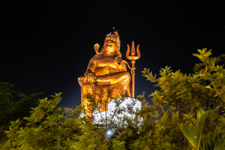 Isolated Statue of holy Hindu Lord Shiva in Meditation Posture with black dark sky at nightの写真素材