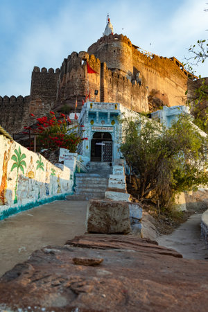 ancient temple with historical fort exterior wall with bright blue sky at morning form flat angle image is taken at jwalamukhi temple jodhpur rajasthan india.の写真素材
