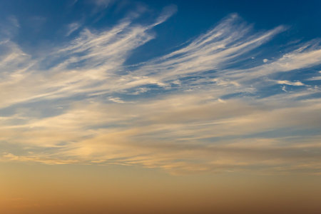 dramatic sunrise orange sky with white cloud at morningの写真素材