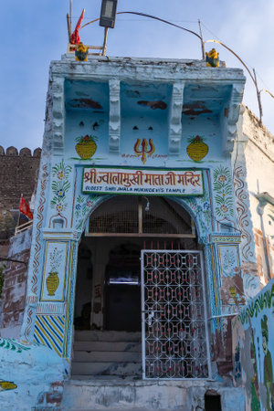 ancient temple with historical fort exterior wall with bright blue sky at morning form flat angle image is taken at jwalamukhi temple jodhpur rajasthan india.の写真素材