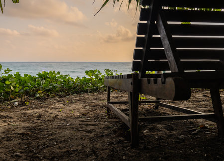 wood beach chair sitting with sea horizon sunrise view from unique perspective at morning image is...