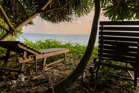 wood beach chair sitting with sea horizon sunrise view from unique perspective at morning image is taken at Kala Pathar Beach havelock Andaman and Nicobar Islands.の写真素材