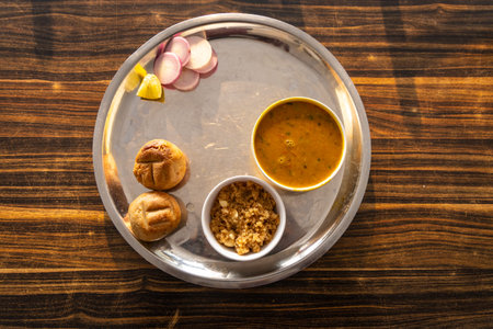 authentic indian traditional food dal bati churma served in steel plate from top angle image is taken at rajasthan. Dal baati churma is a popular dish in the state of Rajasthan, India.の写真素材
