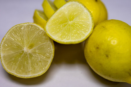 fresh Juicy Lemon Sliced Close-Up on blurred white background studio shotの写真素材