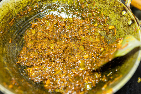 cooking and roasting of Freshly Grated Turmeric in pan Close-Up Studio shotの写真素材