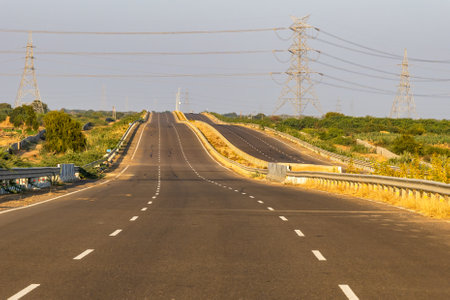 isolated empty tarmac road with bright sunset sky at eveningの写真素材