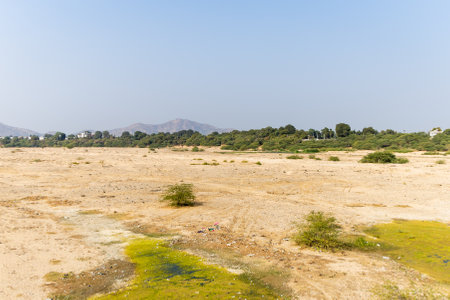 arid riverbed with mountains in the background under daylightの写真素材