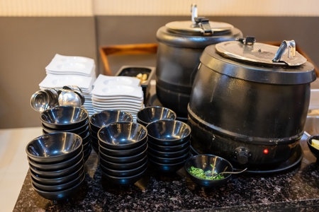 steaming soup jar with bowl arranged for serving at indoorの写真素材