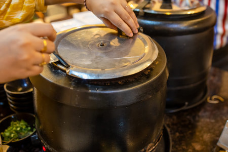 soup jar with human hand ready to serve at indoors