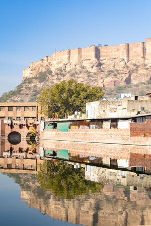 pristine calm lake with water reflection of vintage architecture around at morning image is taken at Gulab sagar talab jodhpur rajasthan india.の写真素材