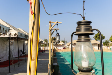 desert camp setup with lalten lamp in natural surroundings with bright skyの写真素材