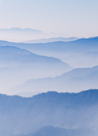 breathtaking mist covered mountain range at morningの写真素材