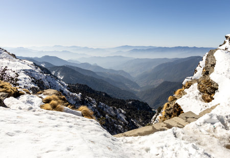 breathtaking mist covered mountain range seen from snowy summitの写真素材
