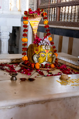 hindu god shivalinga decorated with flower offerings at templeの写真素材