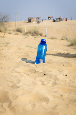 drinking water bottle kept at desert open heat at bright daylightの写真素材
