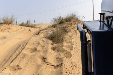 san dunes safari and offloading by jeep at deserts at day from low angle image is taken at rajasthan, India.の写真素材