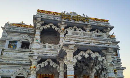 ancient white marble hindu temple unique architecture at dusk from flat angle image is taken at prem mandir uttar pradesh india.の写真素材