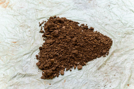 cow dung fertilizer kept at plastic sheet at outdoorの写真素材