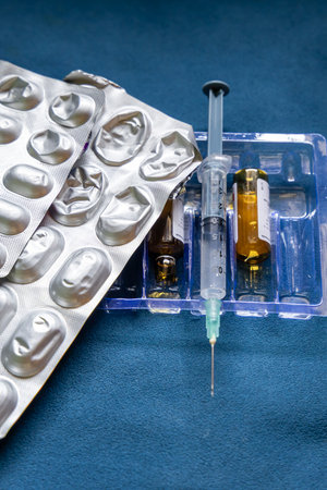 medical tablets with syringe and empty drug bottle indoorsの写真素材