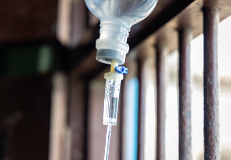 medical infusion iv fluid droplets at hospital in tube with day light viewの写真素材