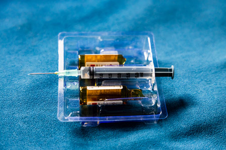 used injection and empty medicine vial in clinical settingの写真素材